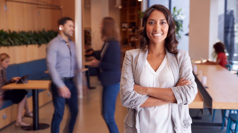 Woman Standing with Arms Crossed in an Office Resized