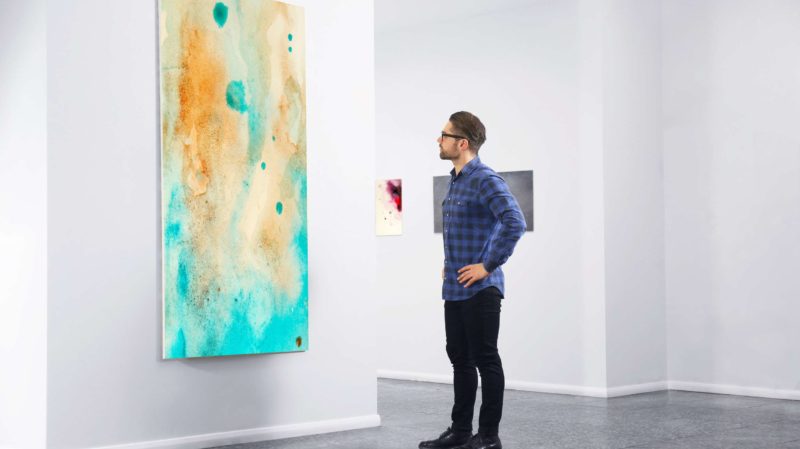 Man Looking at Art in a Gallery