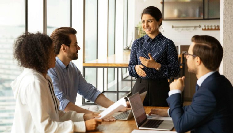 Woman Presenting to Her Colleagues