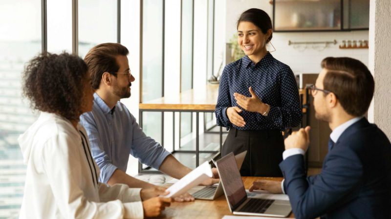 Woman Presenting to Her Colleagues