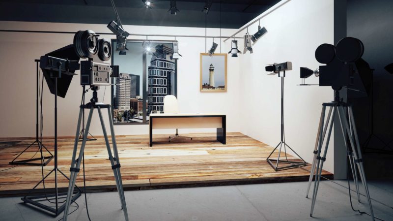 Empty movie set with a desk and video equipment