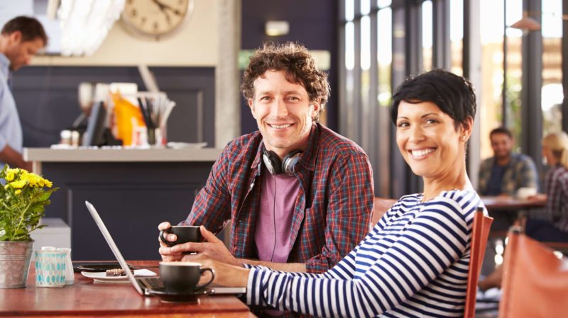 Smiling Man and Woman at a Coffee Shop