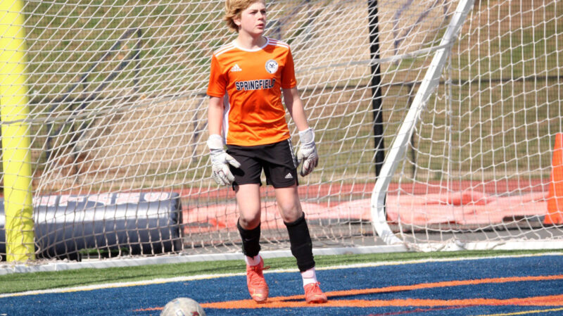 Teenage boy playing soccer as a goalie