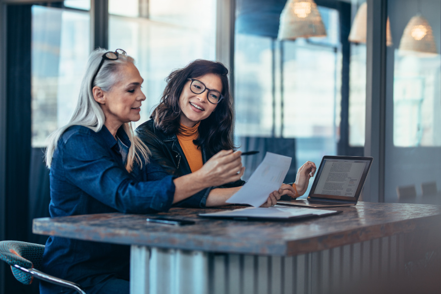 Two business women looking at a document