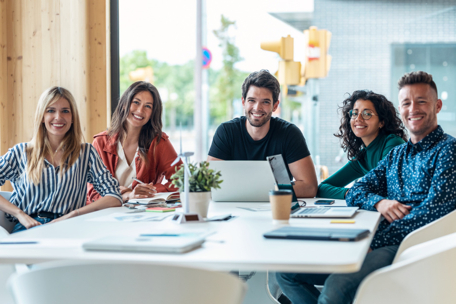 happy staff at a board room table