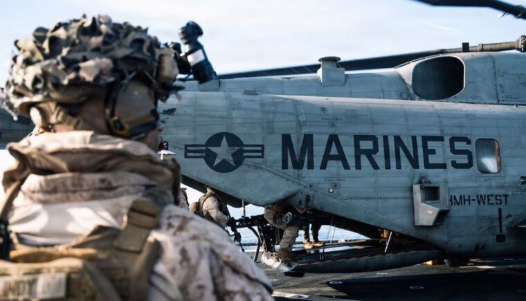 Marine standing near a helo