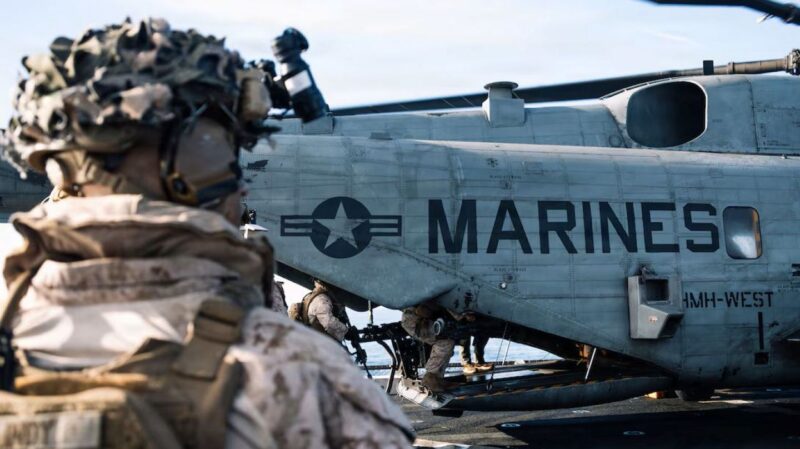 Marine standing near a helo