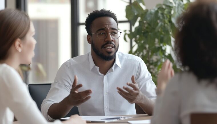 Man speaking with colleagues at the office