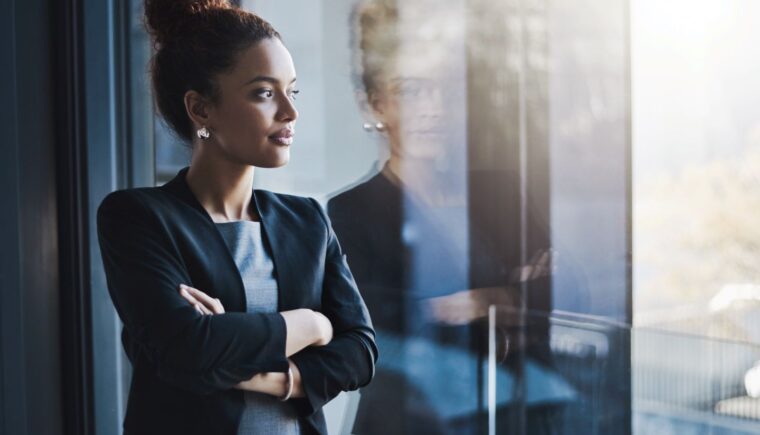 Businesswoman reflecting and looking out the window