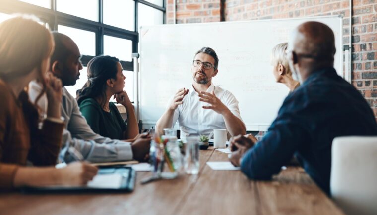 Man leads team meeting in office