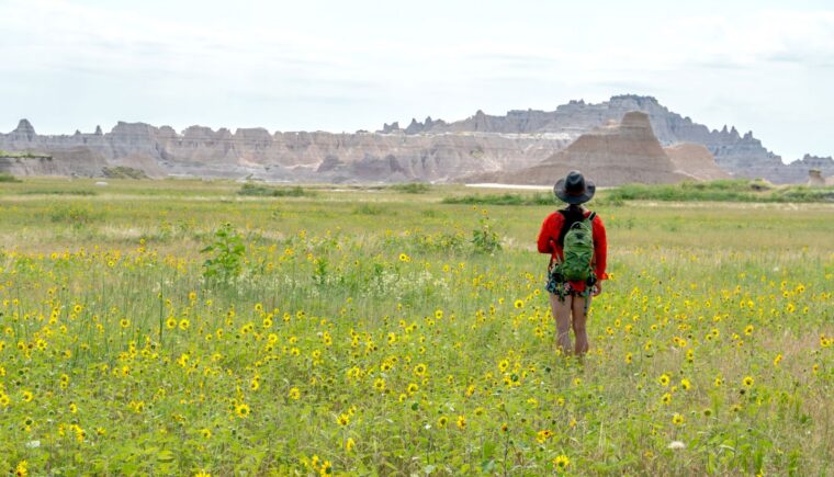 Woman hiking towards a mountain range