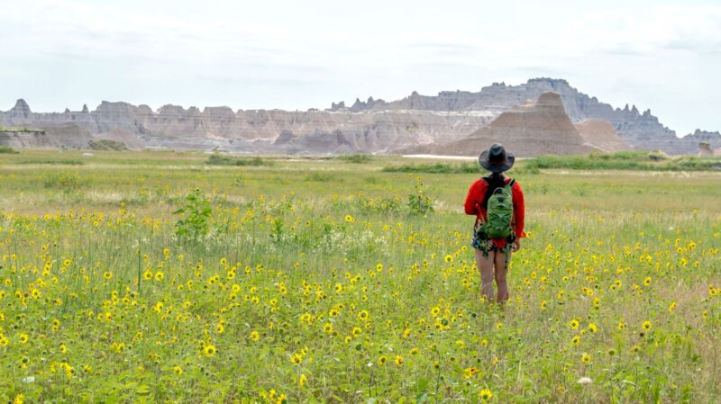 Woman hiking towards a mountain range