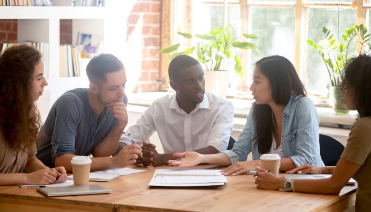 Diverse team discussing a project at work.