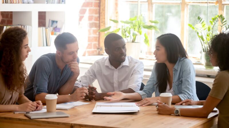 Diverse team discussing a project at work.
