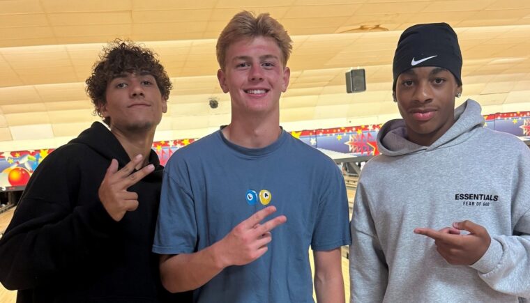 Three teenagers at a bowling alley