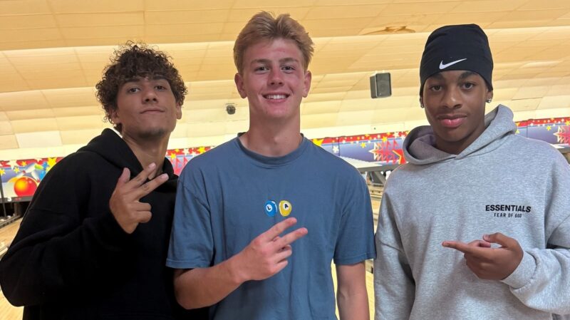 Three teenagers at a bowling alley